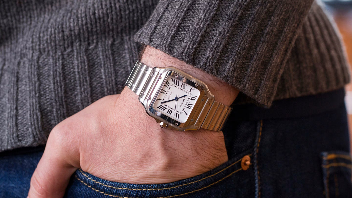 Cartier Santos de Cartier Large in steel with a white Roman-numeral dial worn on the wrist, showing the square bezel with eight screws and the integrated steel bracelet