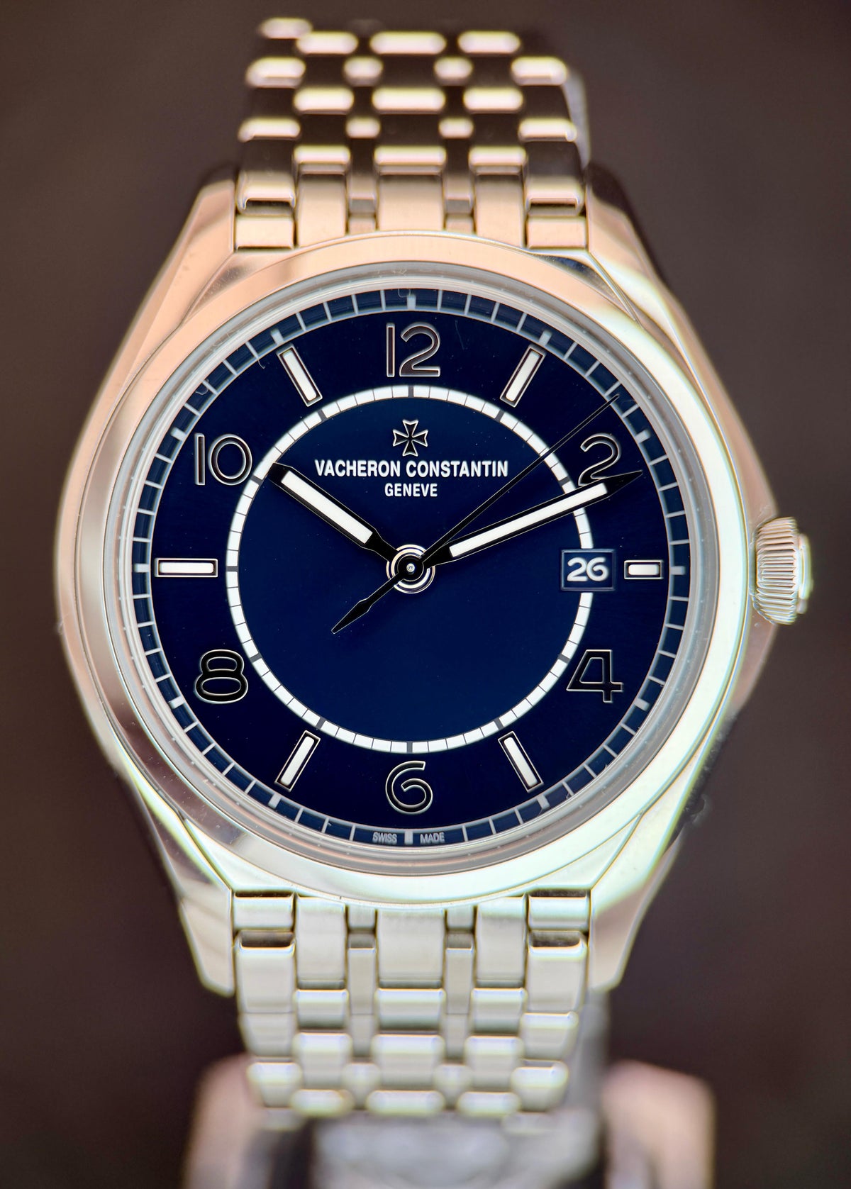 Vacheron Constantin Fiftysix in steel with blue two-zone dial, applied Arabic numerals, date at 3 and steel bracelet on a dark background