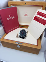 Omega watch in a wooden box with packaging and documents.