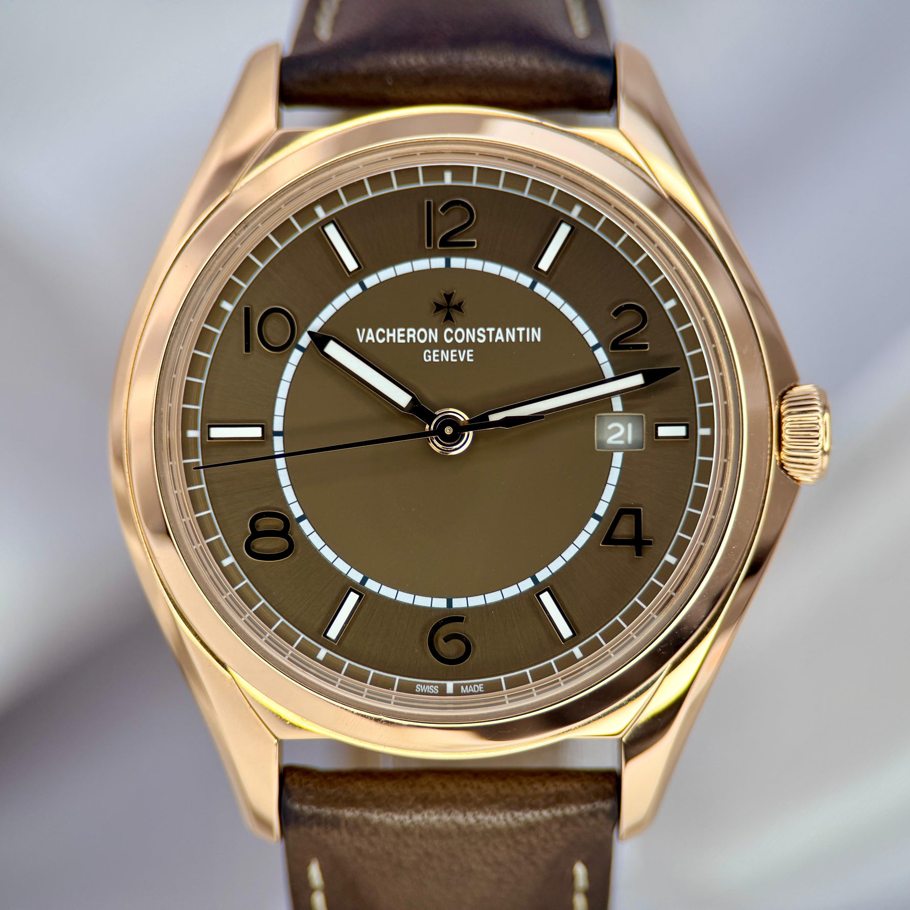 Vacheron Constantin watch with brown leather strap and dark brown dial on a light gray background