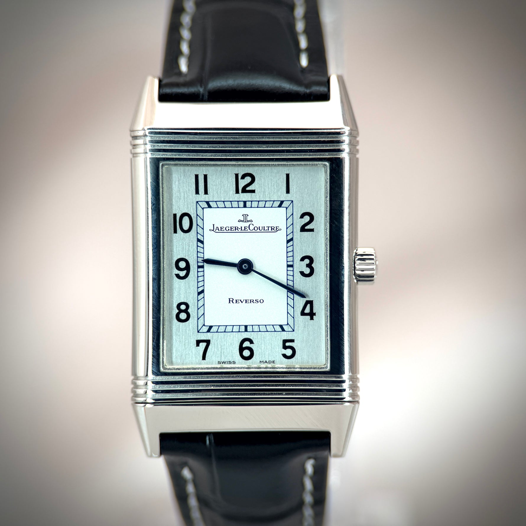 Jaeger-LeCoultre Reverso front view, Art Deco rectangular stainless steel case, silver brushed dial with Arabic numerals, black leather strap