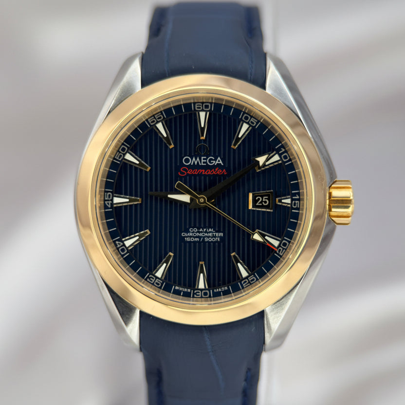 Omega watch with blue strap and gold and silver casing on a white background