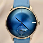 Wristwatch with blue face and strap on a neutral background