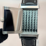 Jaeger-LeCoultre Reverso back panel close-up showing decorative Clous de Paris guilloché texture, stainless steel case with black leather strap