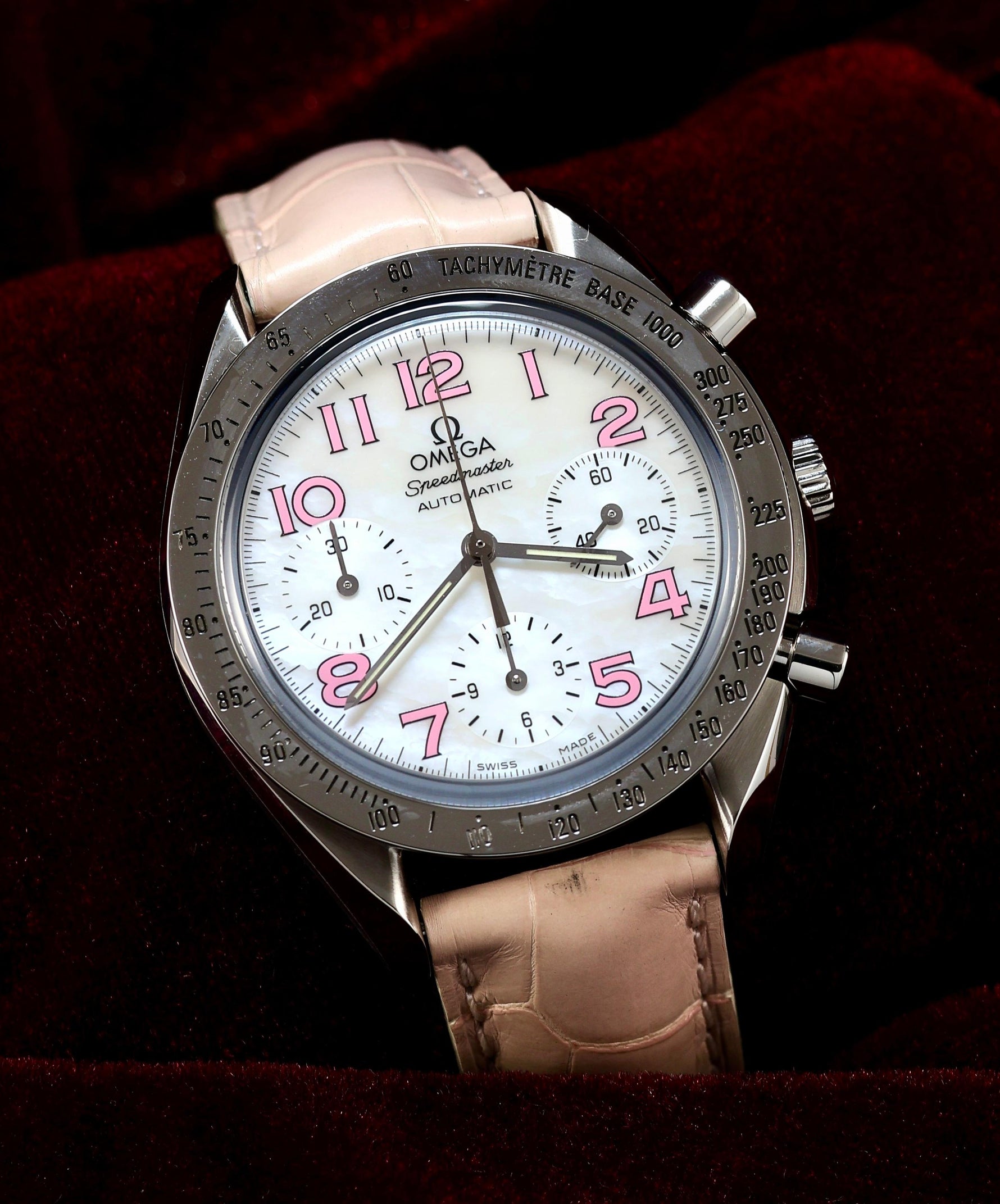 Omega Speedmaster Automatic Chronograph 38mm Ref. 3834.74.34 – front view, white mother-of-pearl dial, pink Arabic numerals, pink leather strap